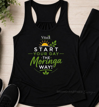 Black women’s performance racerback tank featuring the Vital1 “Start Your Day the Moringa Way” motivational wellness design with sunrise and botanical graphics.