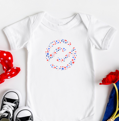 Baby onesie with colorful design, black sneakers, red polka dot headband, blue pants, and red flowers on a white background
