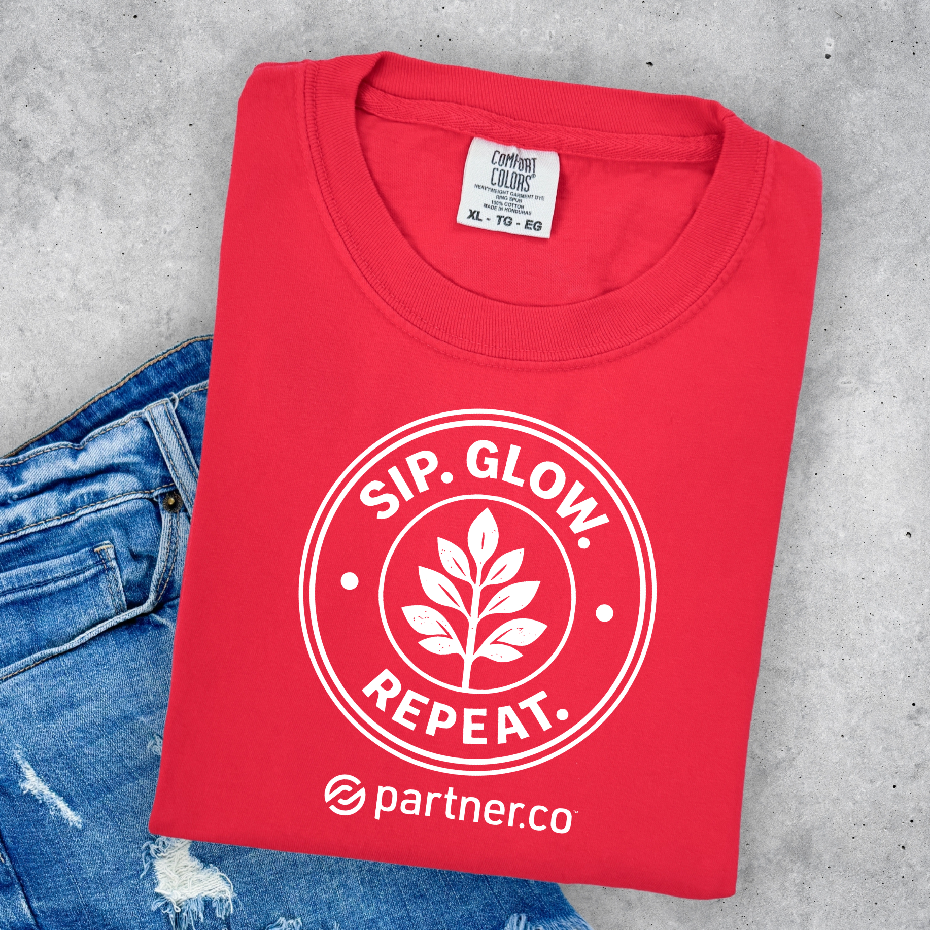 Sip. Glow. Repeat. PartnerCo Moringa launch t-shirt featuring botanical leaf emblem on Comfort Colors
