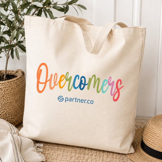 Natural canvas tote bag with colorful Overcomers design
