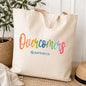 Natural canvas tote bag with colorful Overcomers design