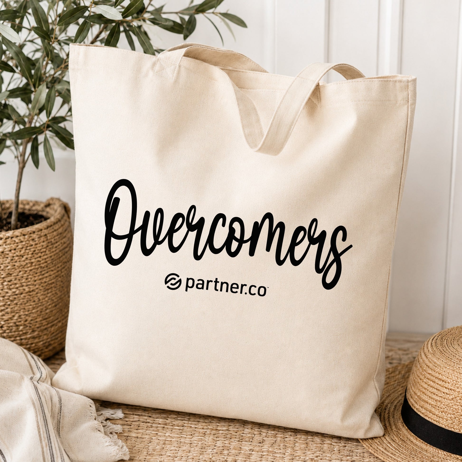 Natural canvas tote bag with black Overcomers design